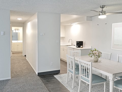 an open kitchen and dining room with a white table and chairs